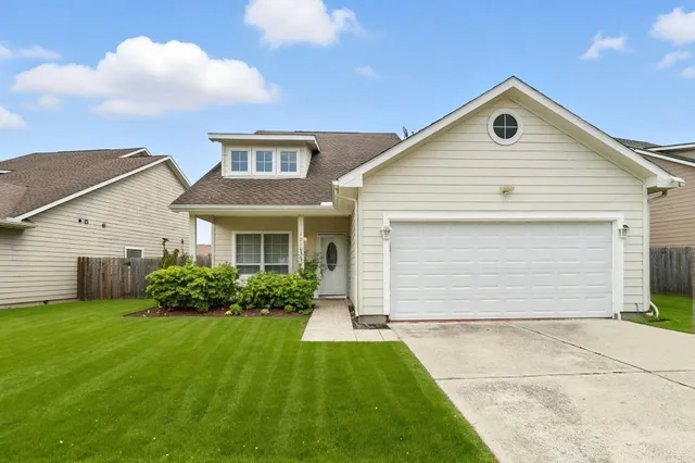 a front view of house with yard and green space