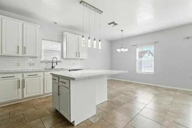 a kitchen with a sink cabinets and window