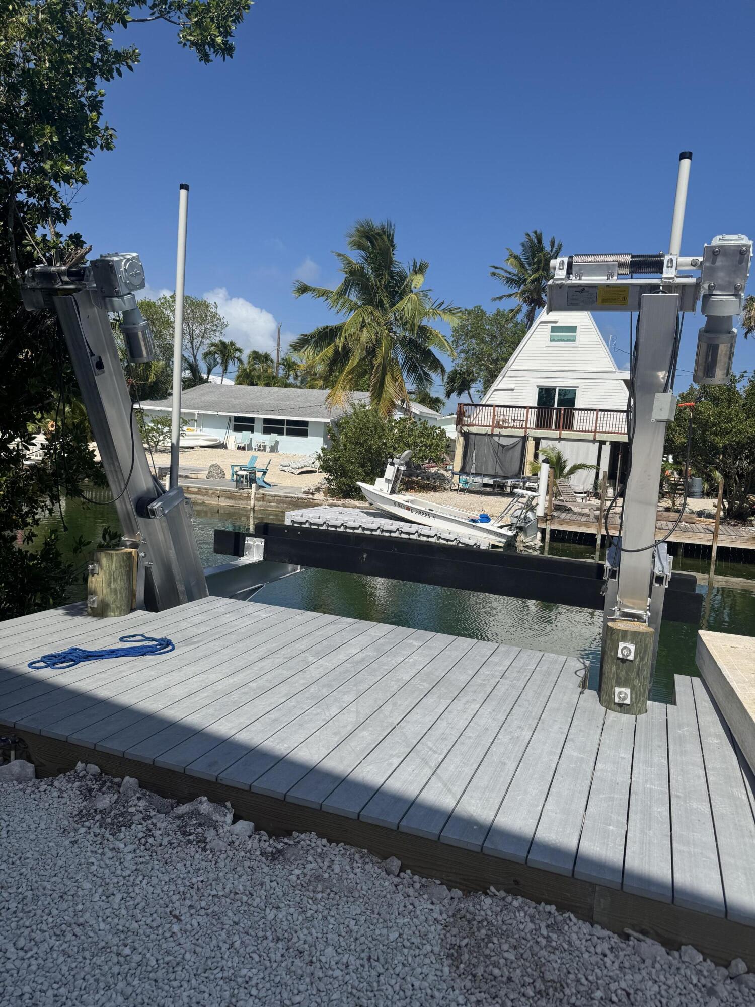 325 Pirates Road Summerland Key, FL 33042 - Photo 5 of 19 a view of roof deck with dining table and chairs with potted plants