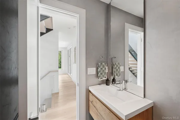 a bathroom with a sink vanity mirror and a bathtub
