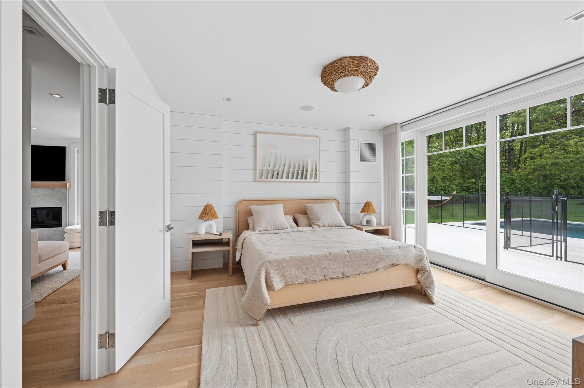 28 Canoe Place Road Hampton Bays, NY 11946 - Photo 14 of 34 a bedroom with a large bed and a large window