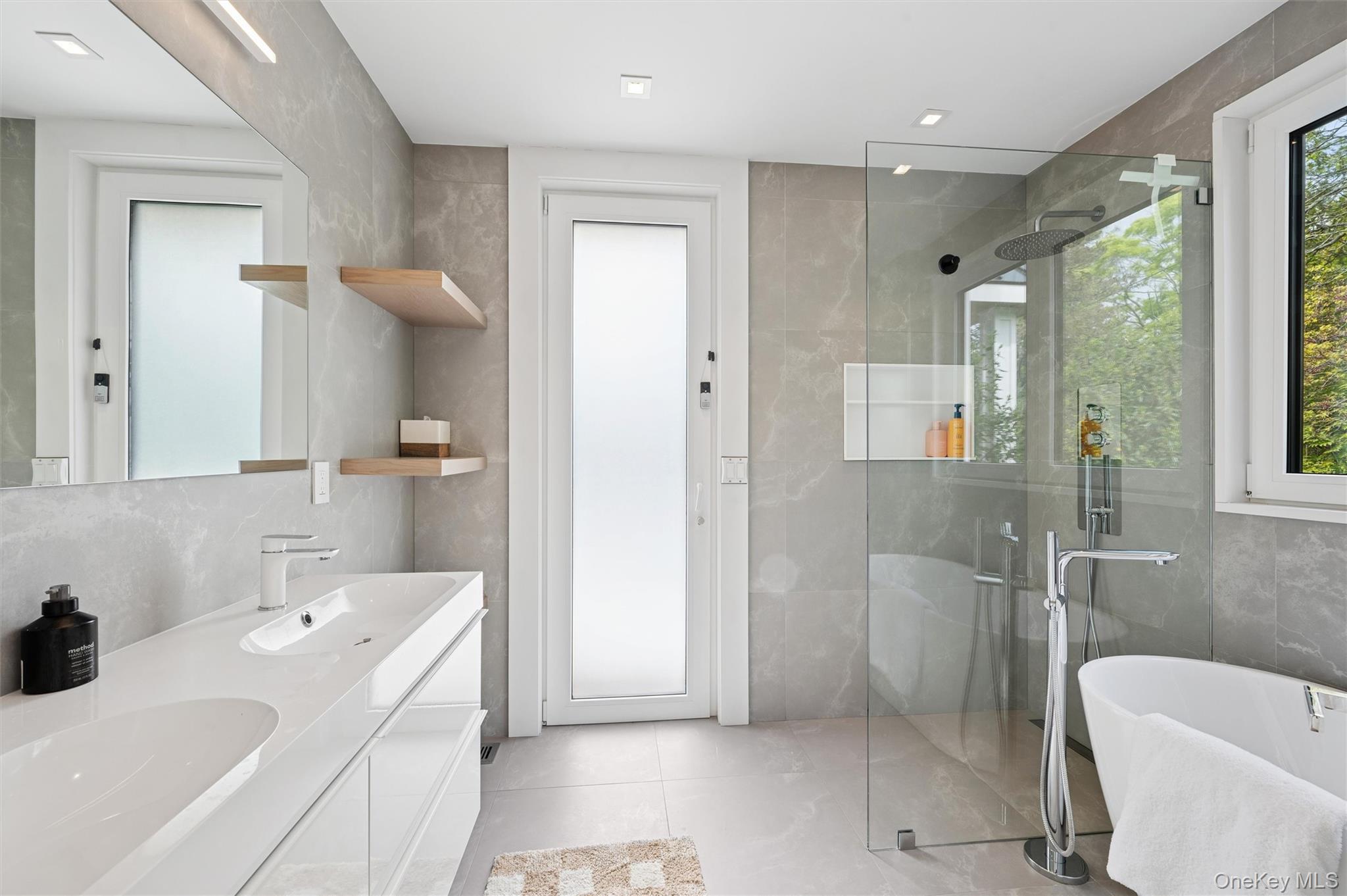 28 Canoe Place Road Hampton Bays, NY 11946 - Photo 15 of 34 a bathroom with a sink a toilet and shower