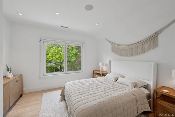 a bedroom with a large bed and a window