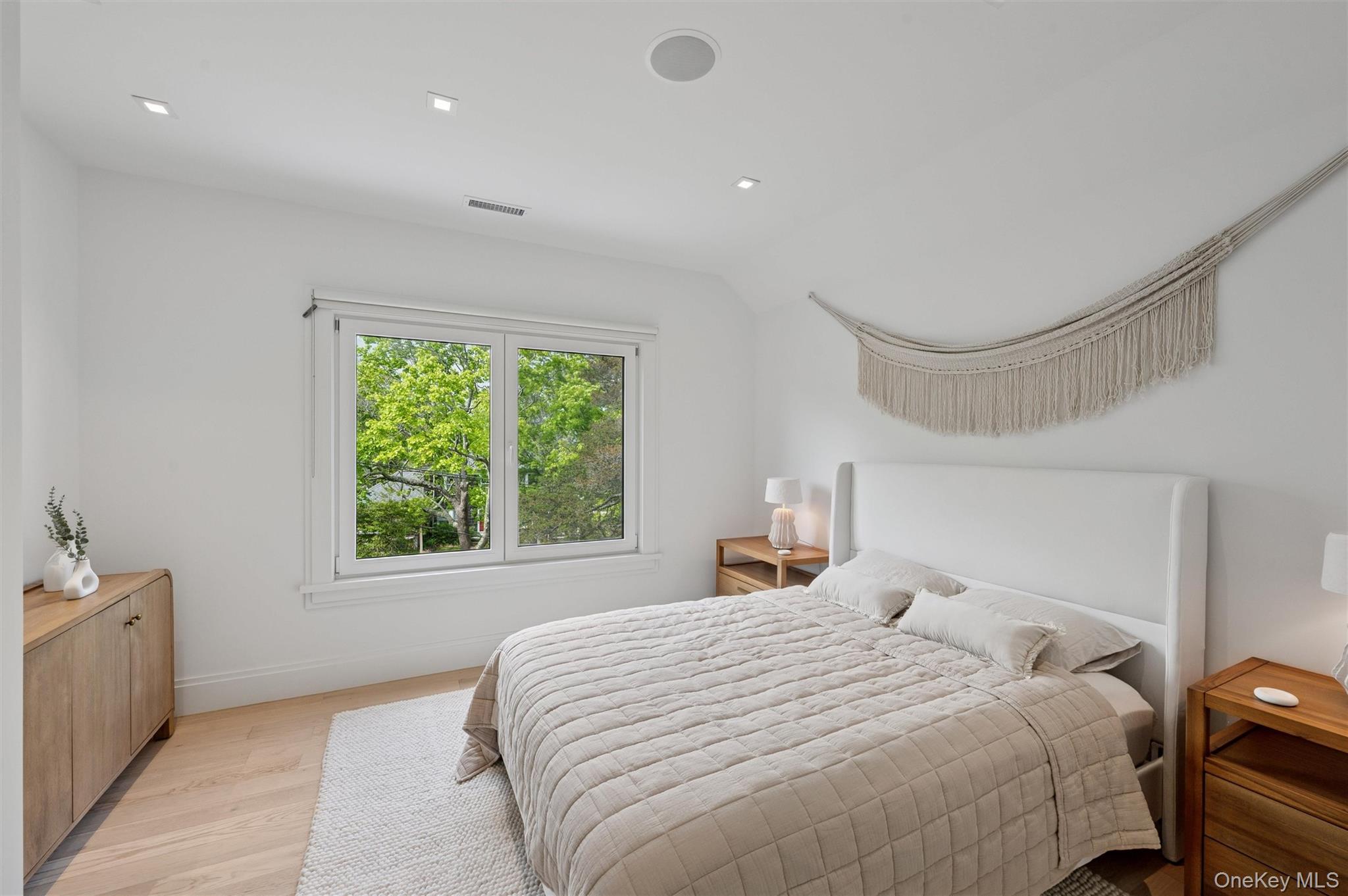 28 Canoe Place Road Hampton Bays, NY 11946 - Photo 21 of 34 a bedroom with a large bed and a window