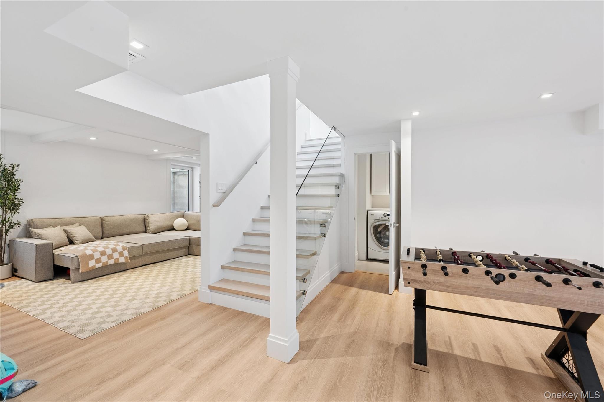 28 Canoe Place Road Hampton Bays, NY 11946 - Photo 24 of 34 a living room with furniture and wooden floor