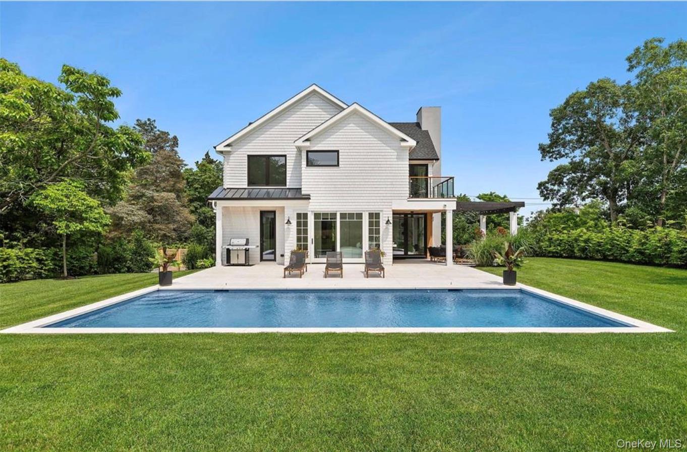 28 Canoe Place Road Hampton Bays, NY 11946 - Photo 26 of 34 a front view of house with yard and green space
