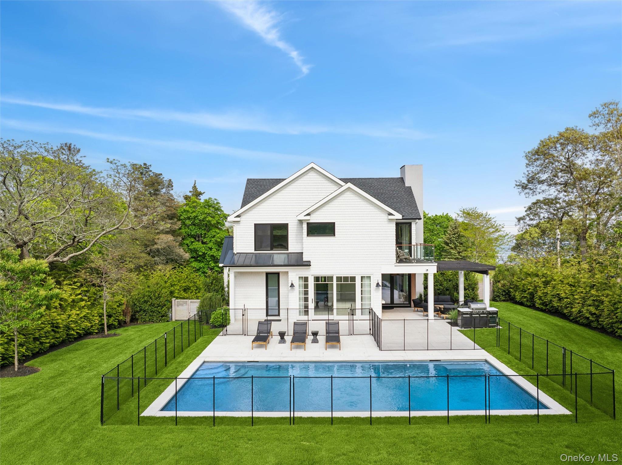 28 Canoe Place Road Hampton Bays, NY 11946 - Photo 30 of 34 a view of house that has a yard