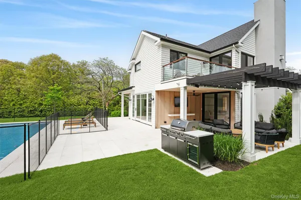 a view of a house with backyard sitting area and garden