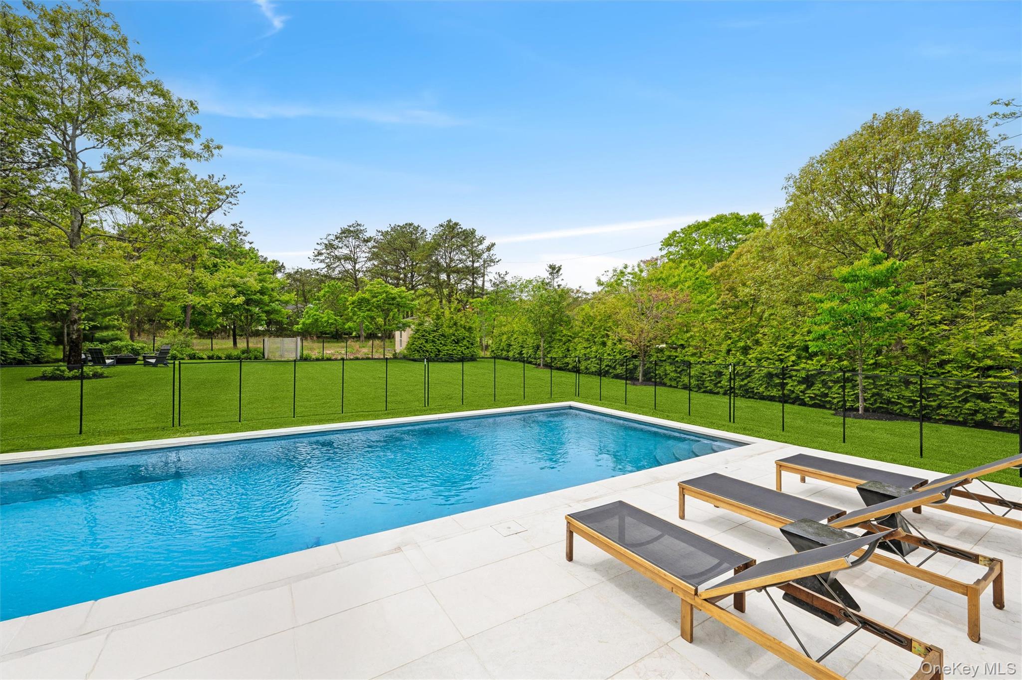 28 Canoe Place Road Hampton Bays, NY 11946 - Photo 33 of 34 a view of swimming pool with a yard