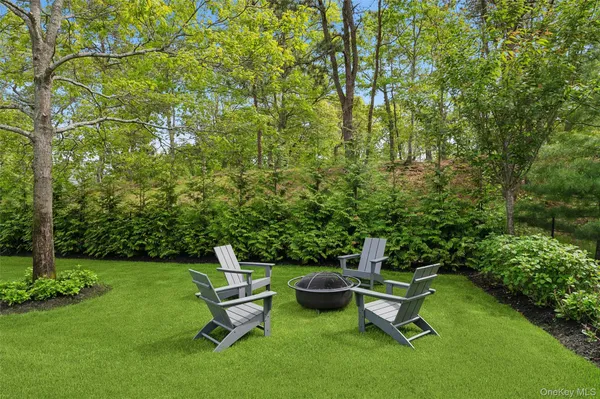 a view of a backyard with sitting area