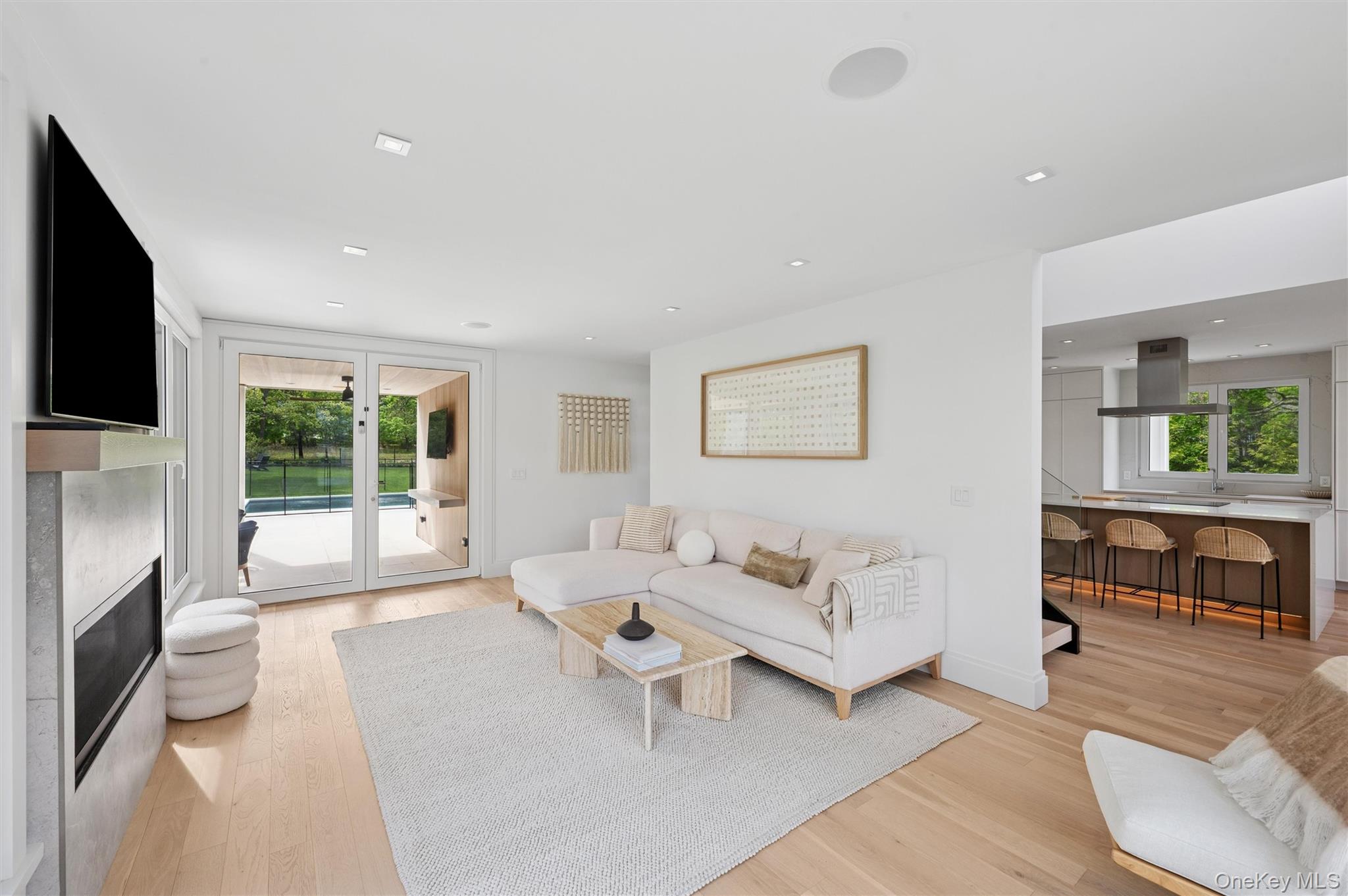 28 Canoe Place Road Hampton Bays, NY 11946 - Photo 4 of 34 a living room with furniture and a flat screen tv