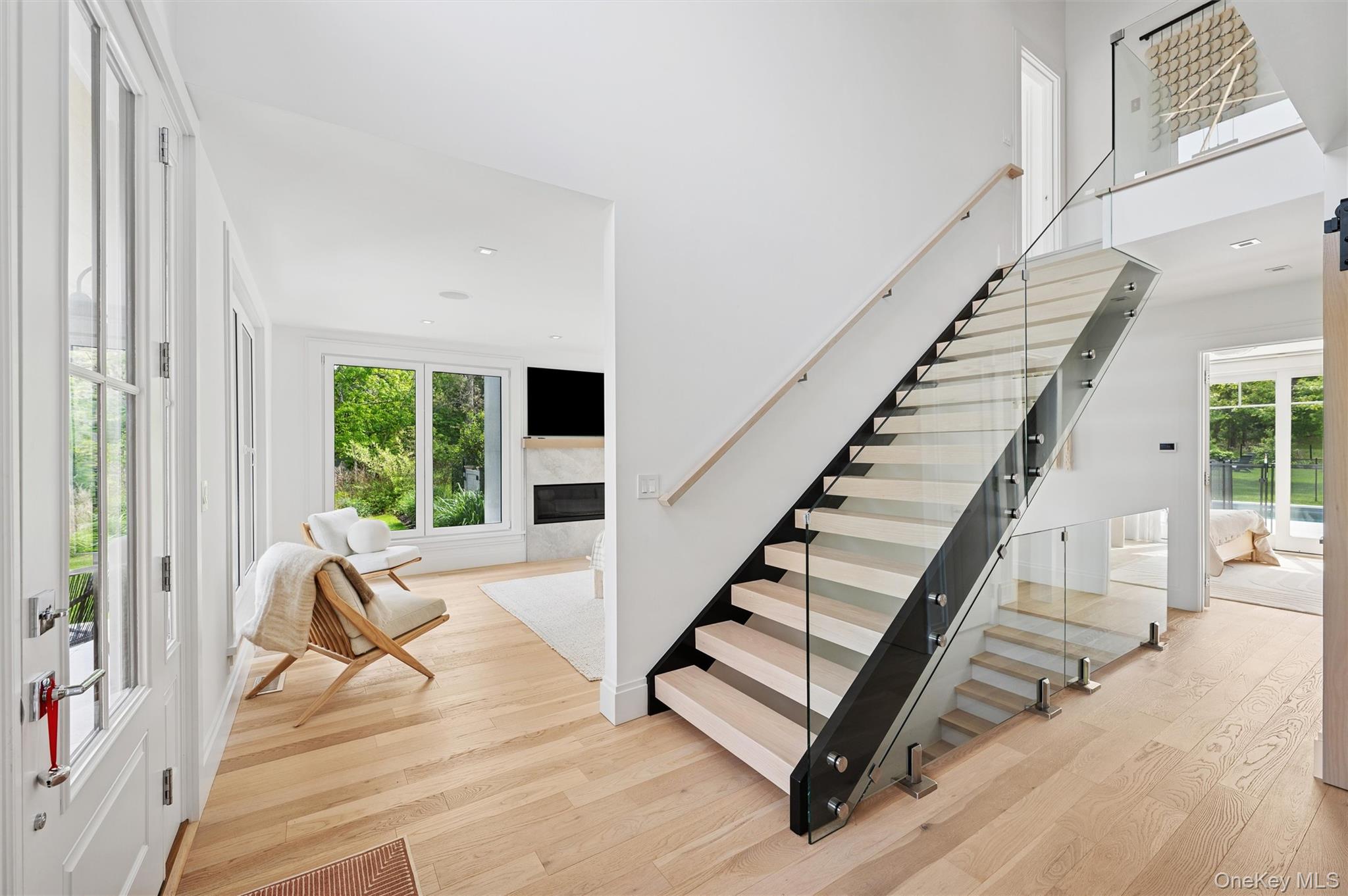 28 Canoe Place Road Hampton Bays, NY 11946 - Photo 5 of 34 a view of entryway and hall with wooden floor
