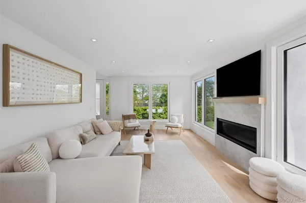 a living room with furniture a flat screen tv and a fireplace