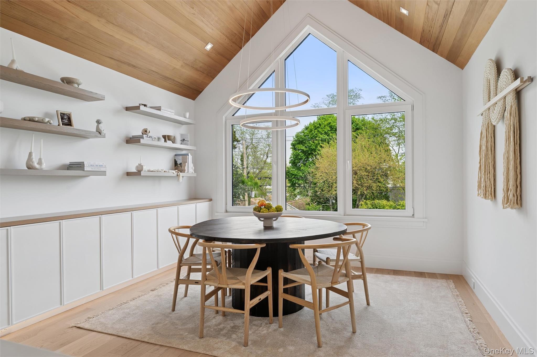 28 Canoe Place Road Hampton Bays, NY 11946 - Photo 10 of 34 a dining room with furniture and window