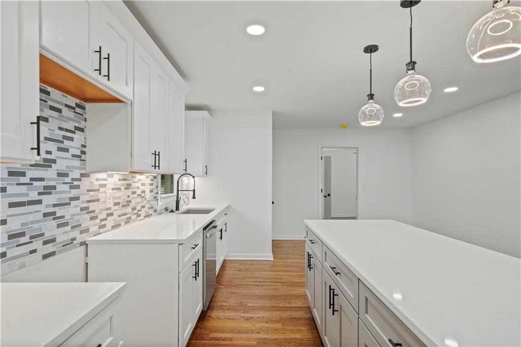 134 Normandy Drive Southwest Marietta, GA 30064 - Photo 17 of 26 a kitchen with a sink and a stove with wooden floor