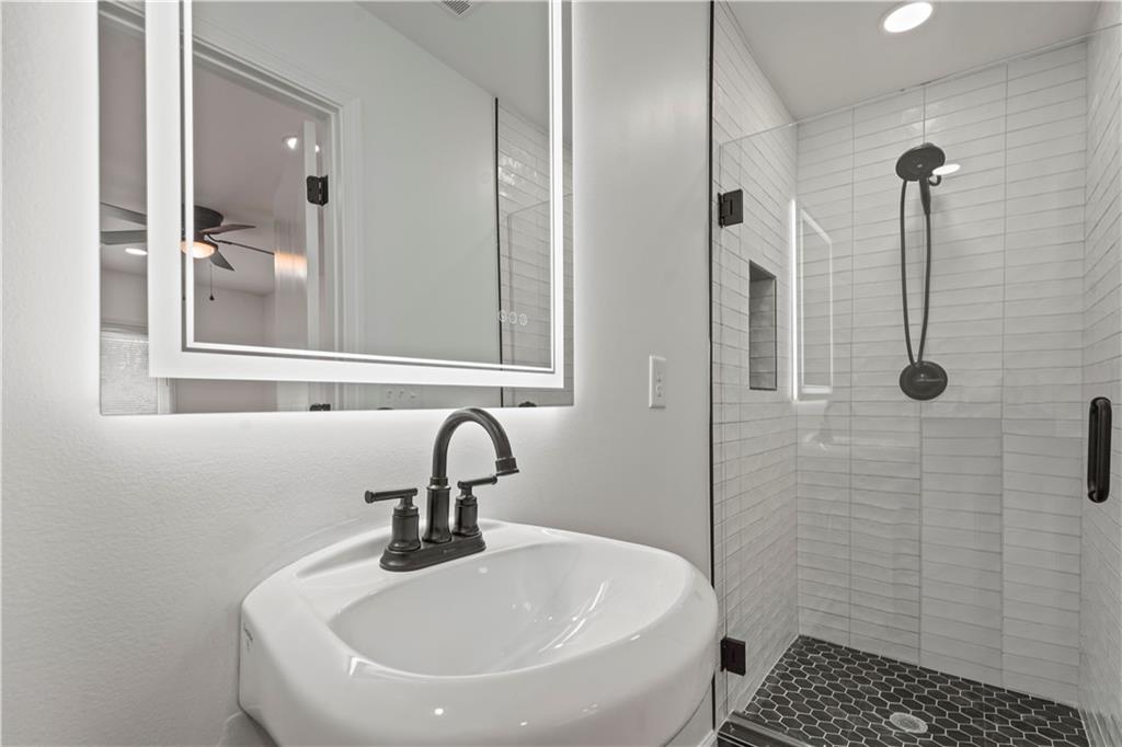 134 Normandy Drive Southwest Marietta, GA 30064 - Photo 20 of 26 a bathroom with a sink a toilet and shower