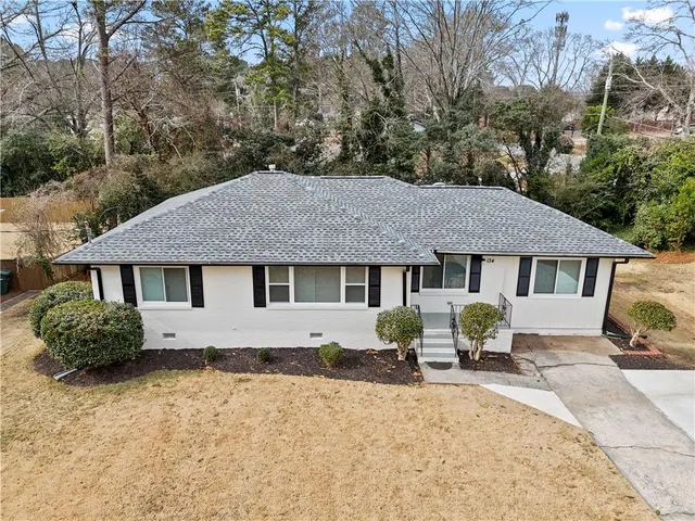 a house that has a tree in front of it