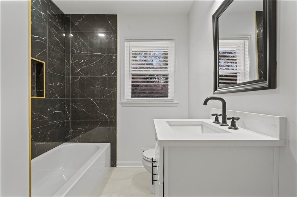 134 Normandy Drive Southwest Marietta, GA 30064 - Photo 24 of 26 a bathroom with a sink mirror toilet and bathtub