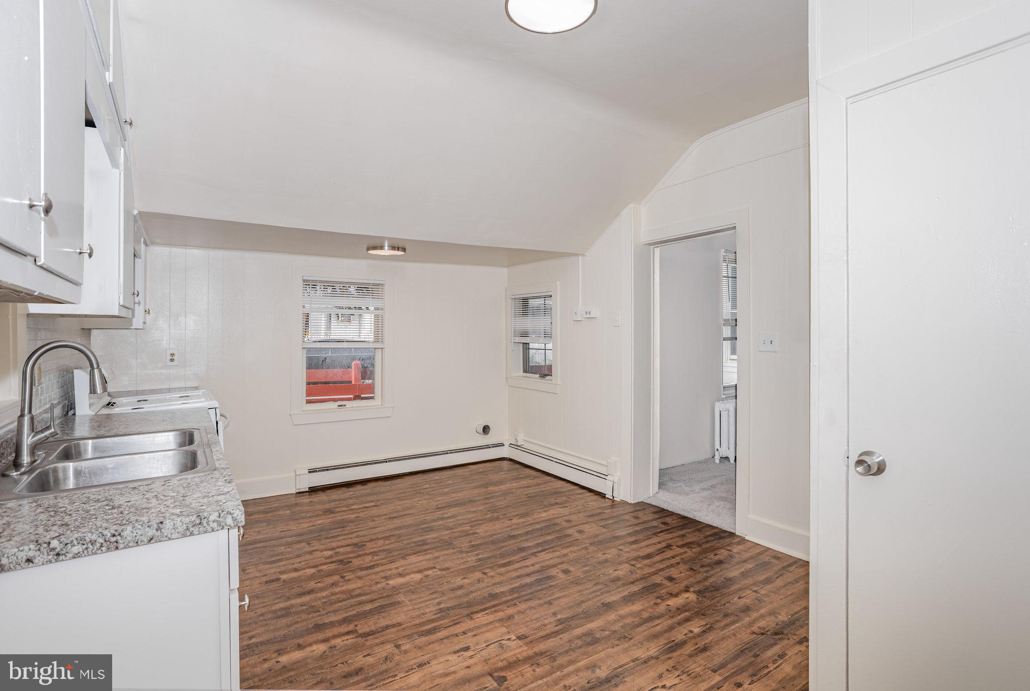 402 Spruce Street Steelton, PA 17113 - Photo 14 of 32 a view of a kitchen cabinets a sink and dishwasher wooden floor