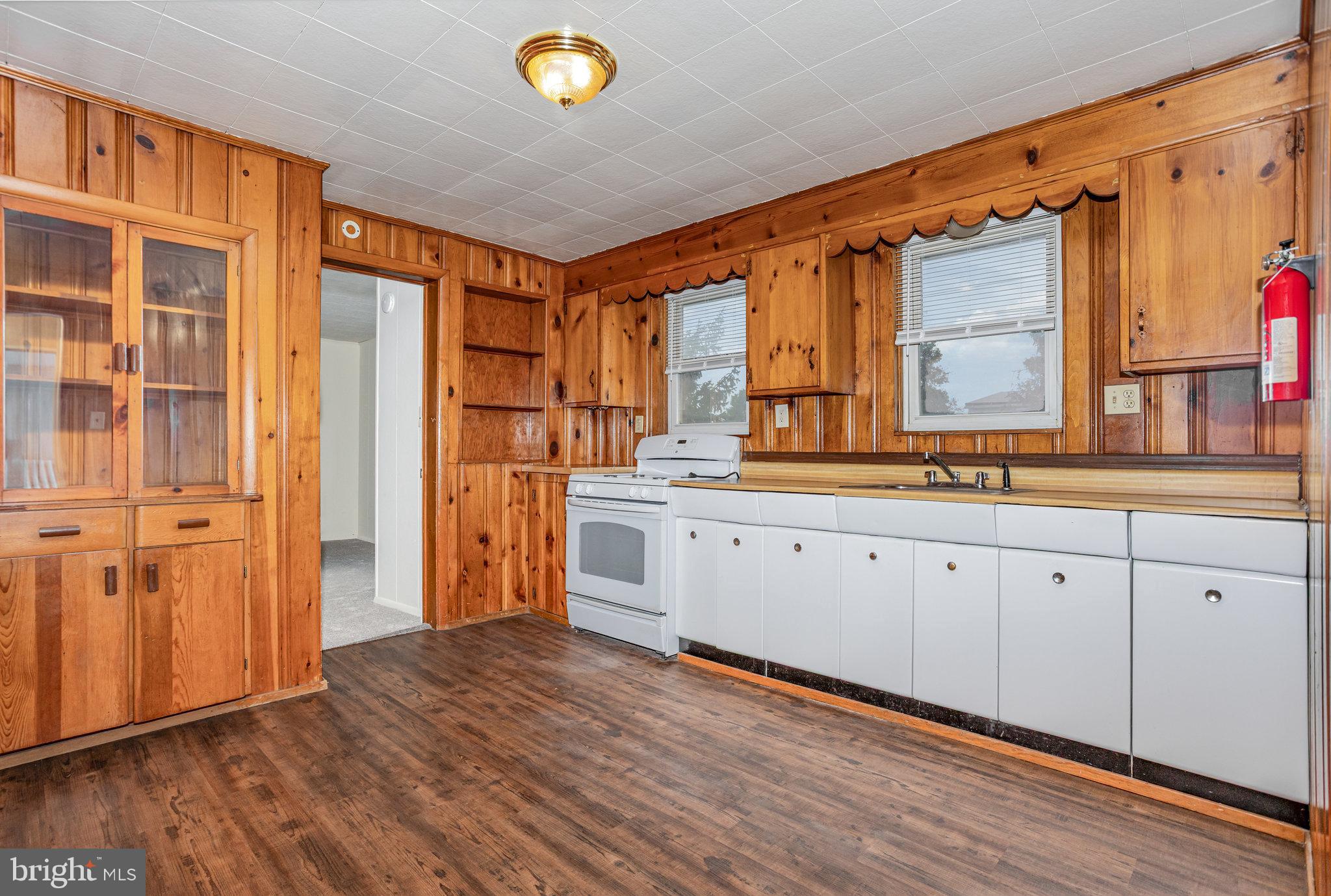 402 Spruce Street Steelton, PA 17113 - Photo 16 of 32 a kitchen with stainless steel appliances granite countertop a refrigerator a sink dishwasher and wooden cabinets with wooden floor
