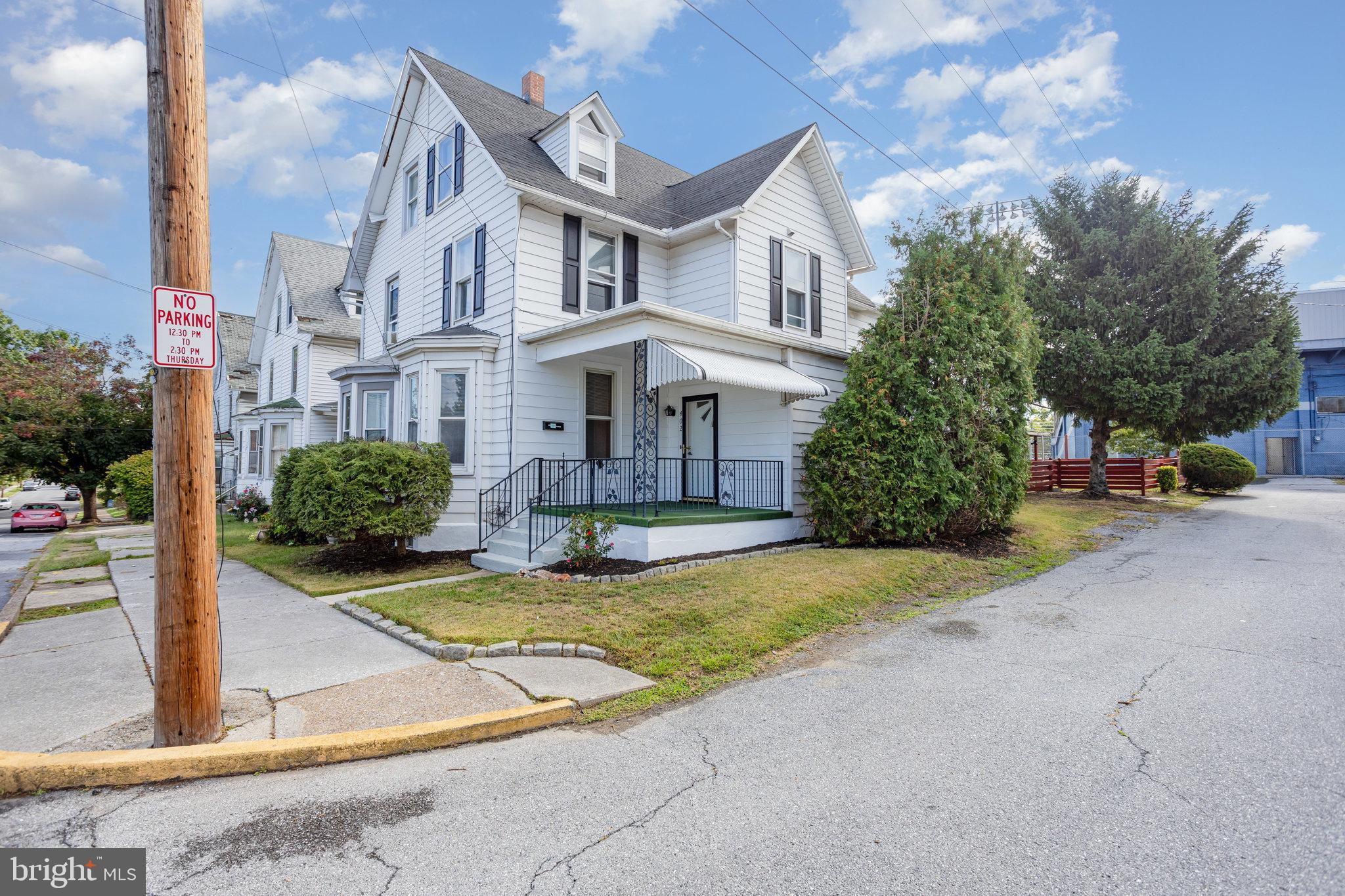 402 Spruce Street Steelton, PA 17113 - Photo 3 of 32 a view of a white house with large windows next to a road