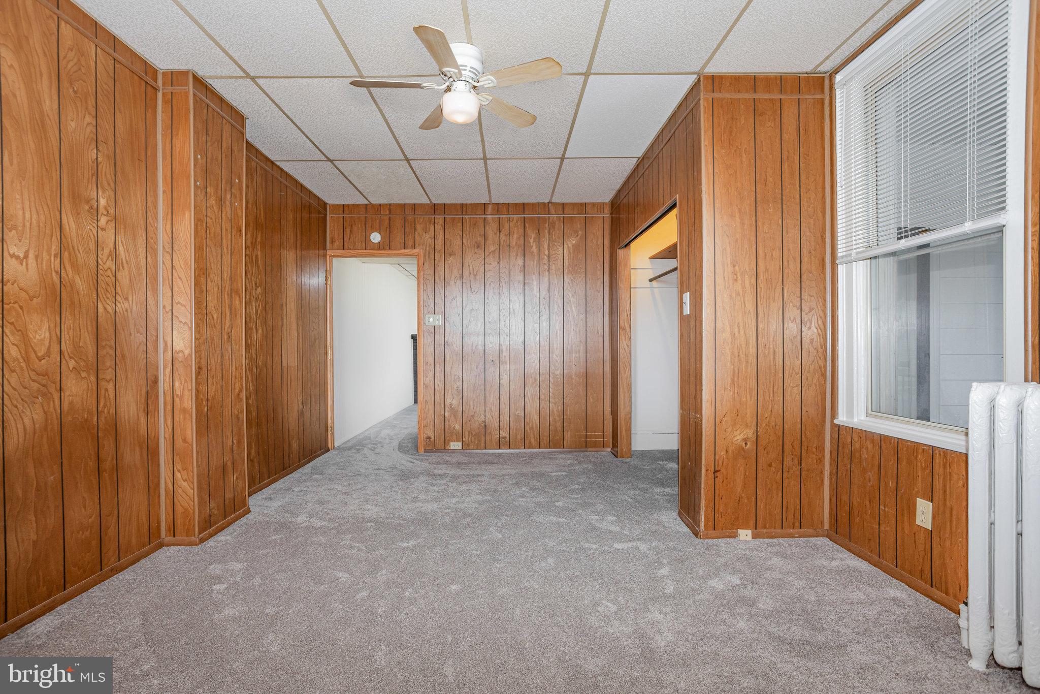 402 Spruce Street Steelton, PA 17113 - Photo 10 of 32 an empty room with chandelier fan and windows