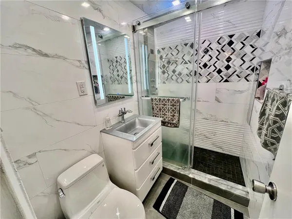 a bathroom with a sink toilet and shower