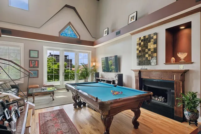 a living room with a pool table and a fireplace