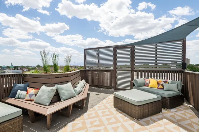 a view of a roof deck with furniture
