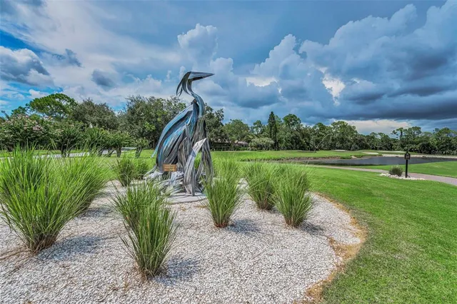 a view of a lake with a big yard and a fountain