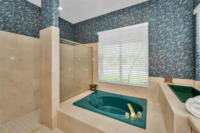 a bathroom with a granite countertop sink a mirror and shower