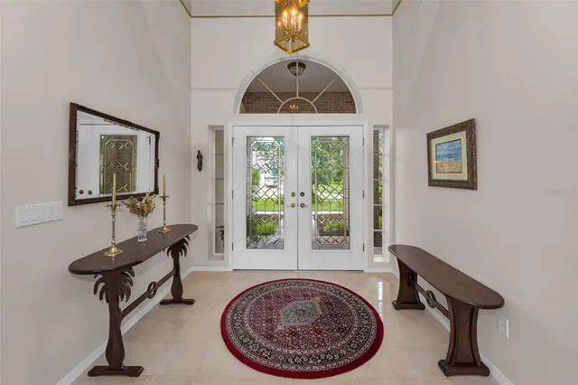 a living room with furniture and large windows