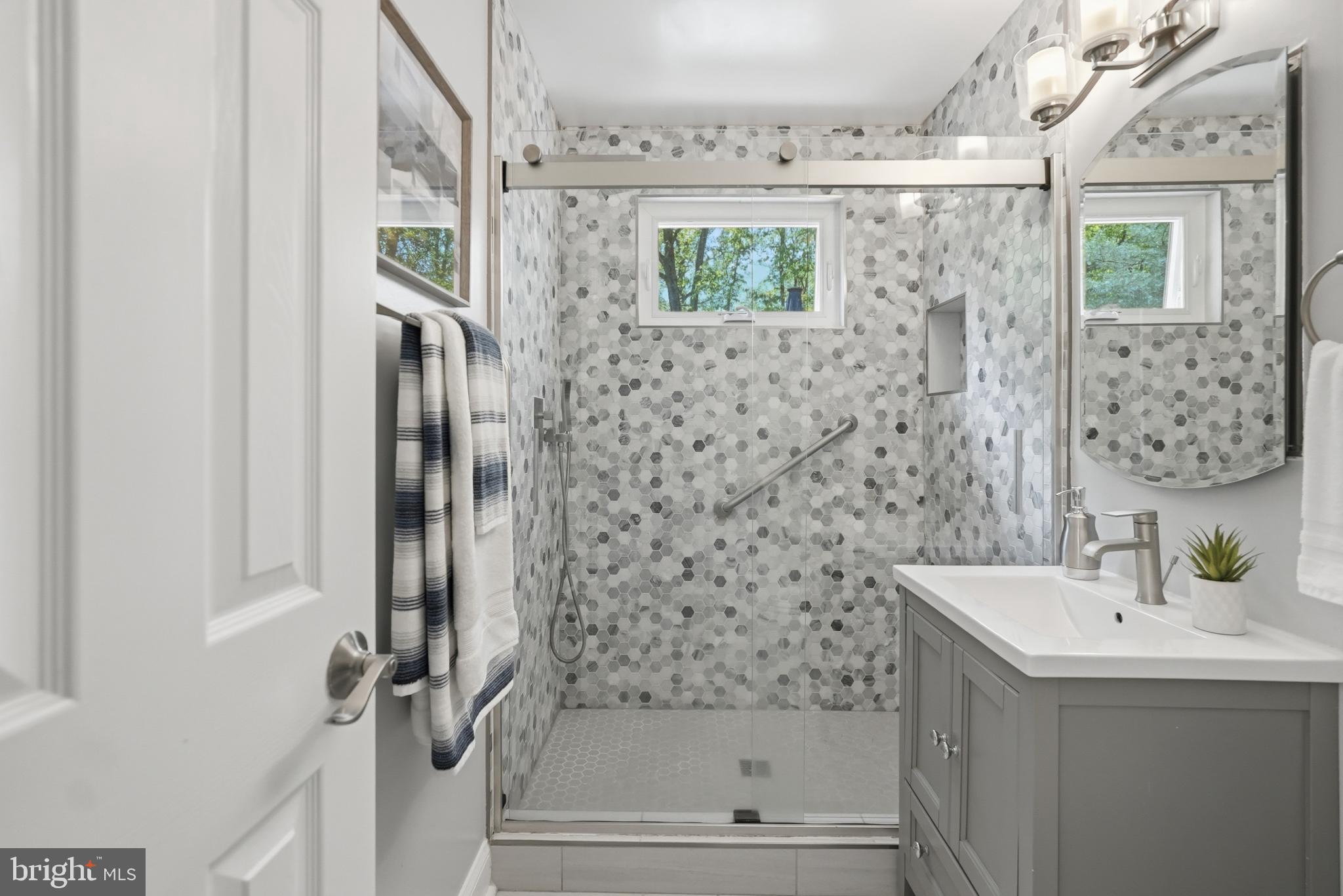 7006 Barnack Drive Springfield, VA 22152 - Photo 25 of 56 a bathroom with a sink a mirror and a shower