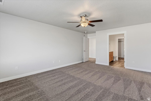 2028 West Grace Way Layton, UT 84041 - Photo 14 of 36 Unfurnished bedroom with ensuite bath, a ceiling fan, carpet floors, and a textured ceiling