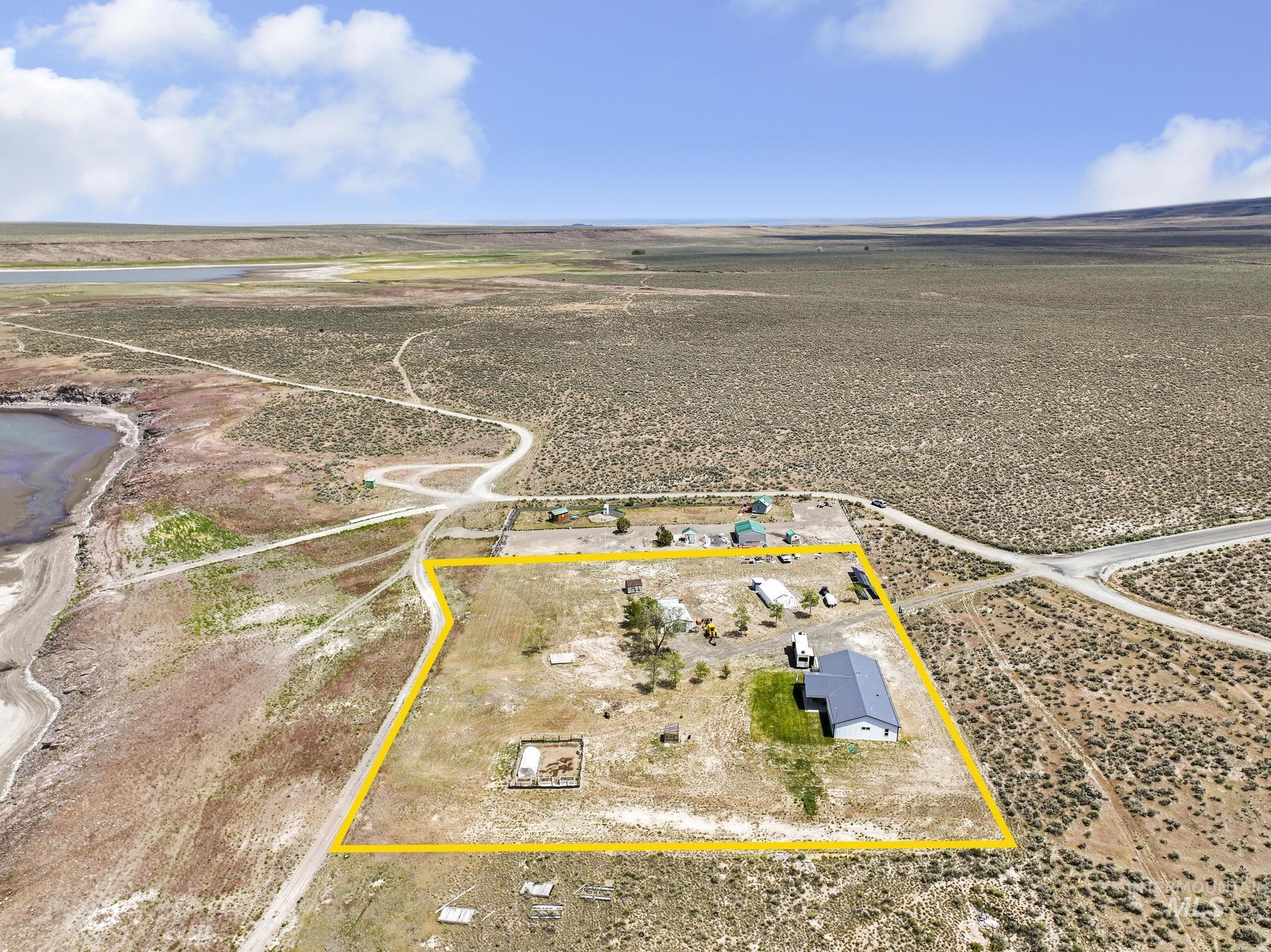 758 Cedar Crk Road Rogerson, ID 83302 - Photo 50 of 50 Expansive lot featuring a single-story residence with a dark gray roof, multiple outbuildings, and a surrounding natural landscape