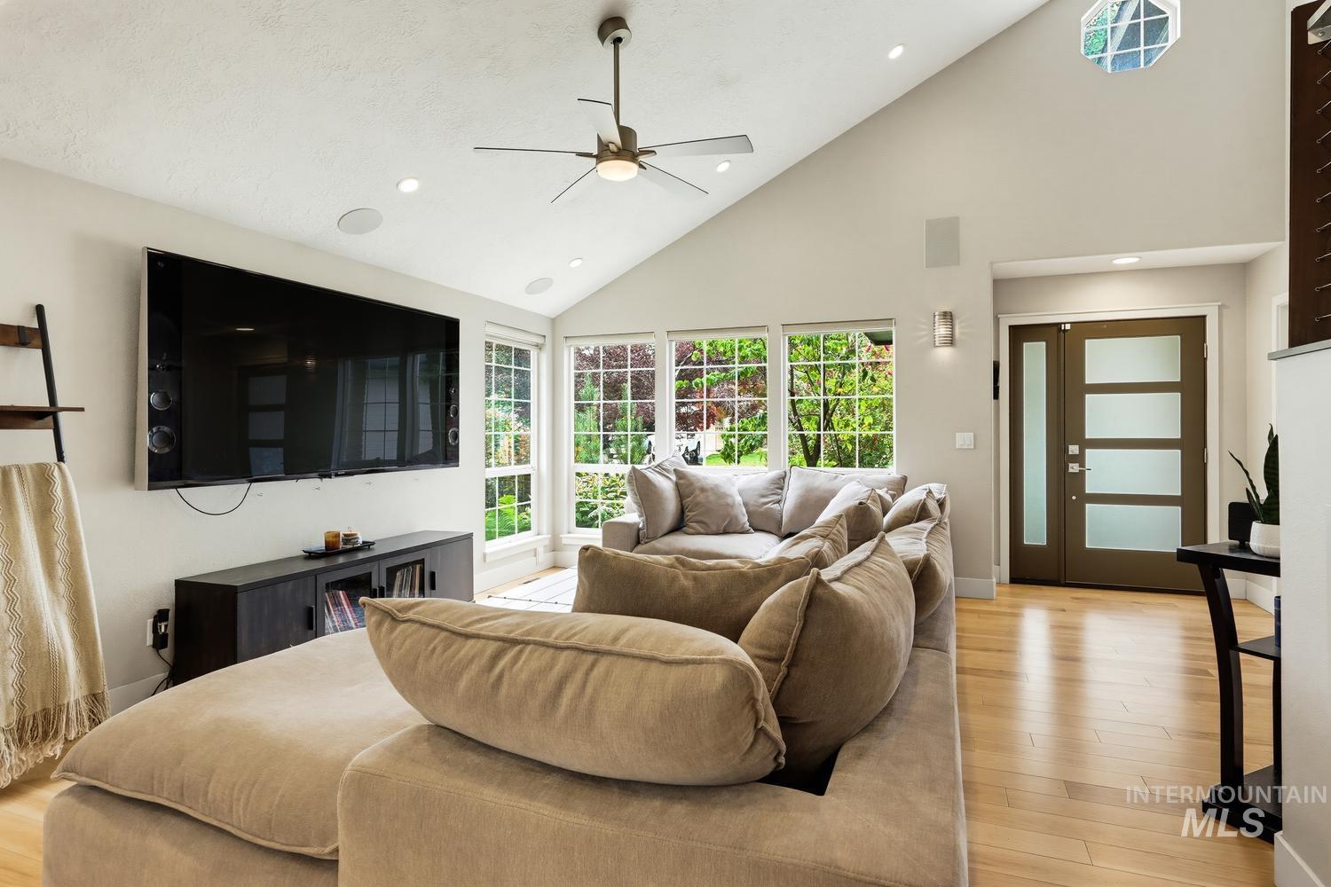 369 South Winthrop Way Boise, ID 83709 - Photo 5 of 50 Living area featuring vaulted ceilings with a ceiling fan, recessed lighting, and light wood-finish flooring