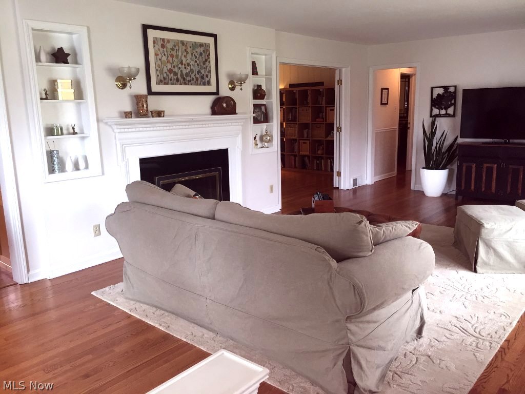 3134 Orchard Road Silver Lake, OH 44224 - Photo 7 of 24 Warm and inviting living room with hard wood floor, built-ins and gas fireplace.