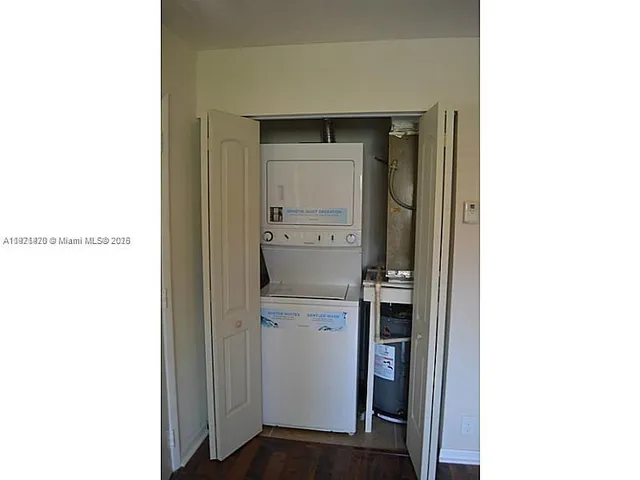 a kitchen with a refrigerator and cabinets