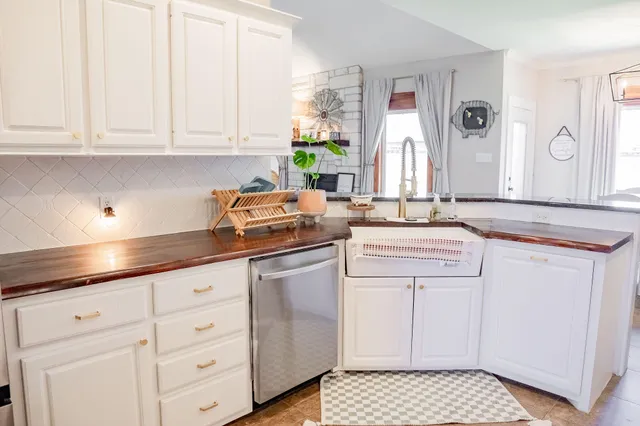 a kitchen with granite countertop white cabinets and white appliances