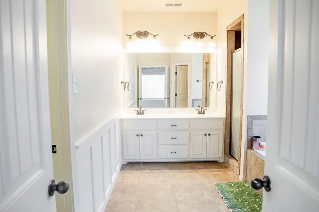 a white bath tub sitting next to a toilet