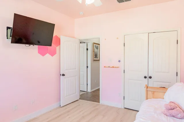 a bedroom with a bed and a flat screen tv