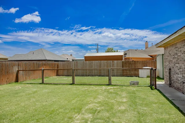 a backyard with tall trees