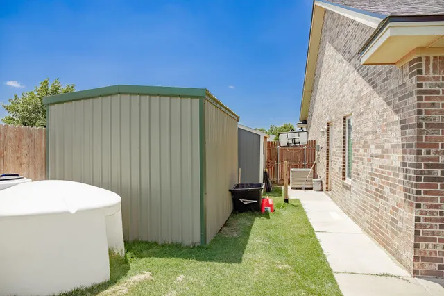 a view of an empty room with wooden floor and a chair
