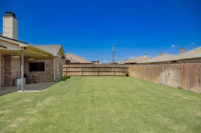 a view of a house with backyard and porch