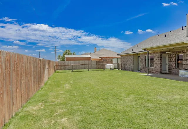 a backyard of a house with table and chairs
