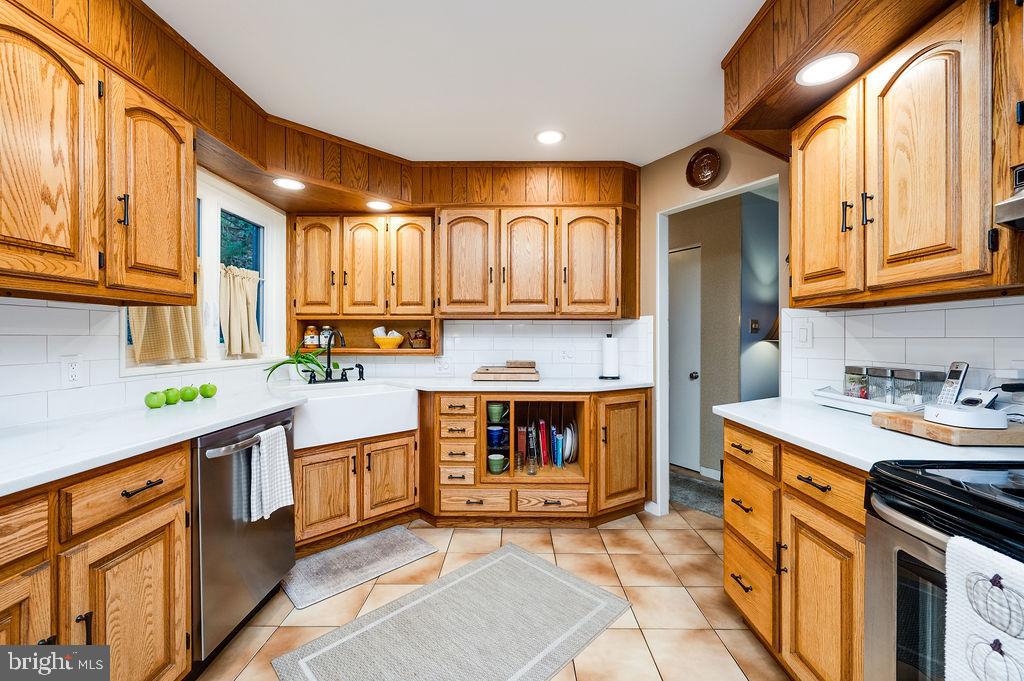 199 Deer Hill Lane Reading, PA 19607 - Photo 17 of 65 a kitchen with stainless steel appliances granite countertop a stove a sink and a microwave