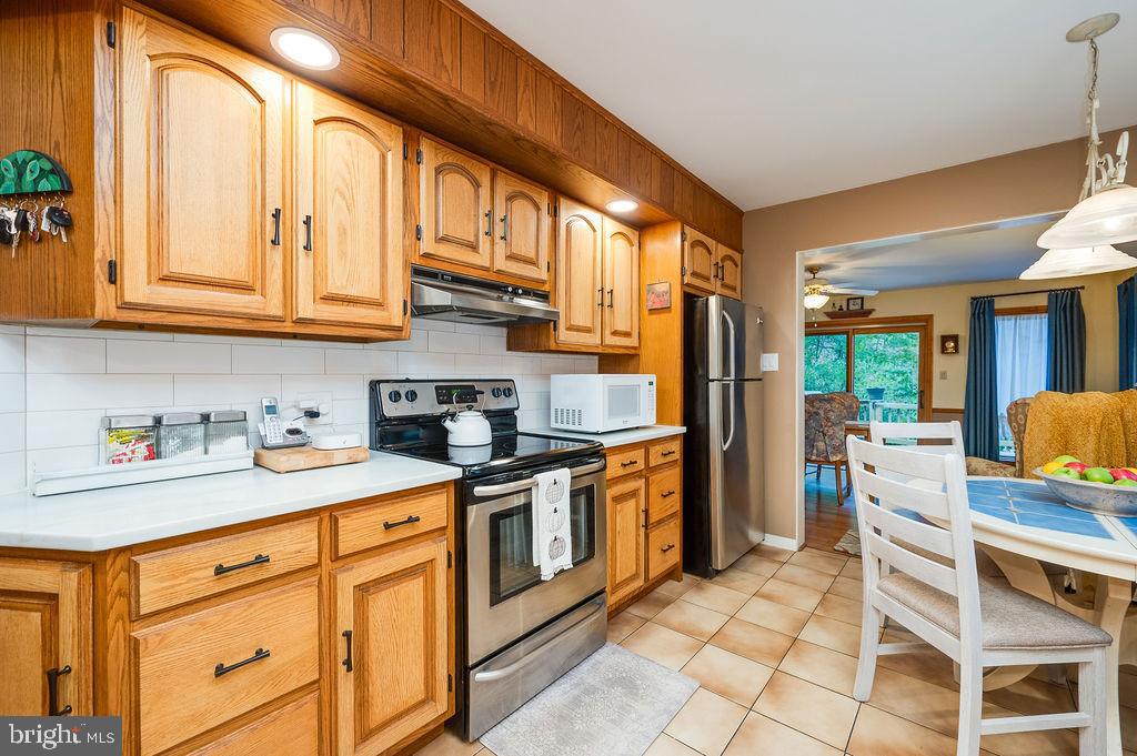 199 Deer Hill Lane Reading, PA 19607 - Photo 18 of 65 a kitchen with stainless steel appliances granite countertop a sink and cabinets