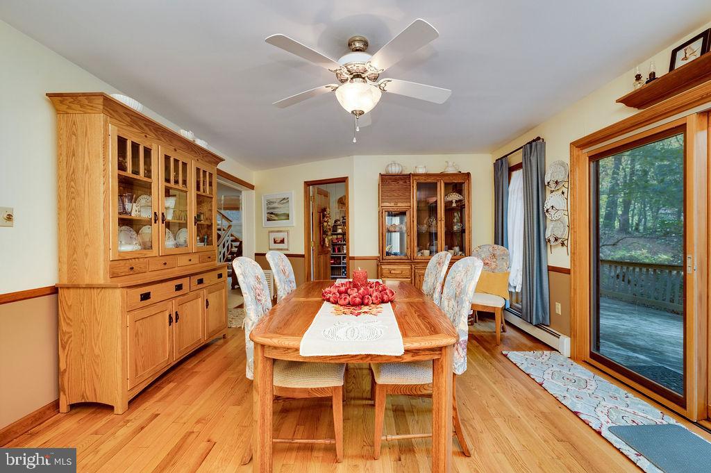 199 Deer Hill Lane Reading, PA 19607 - Photo 22 of 65 a dining room with furniture a chandelier and wooden floor