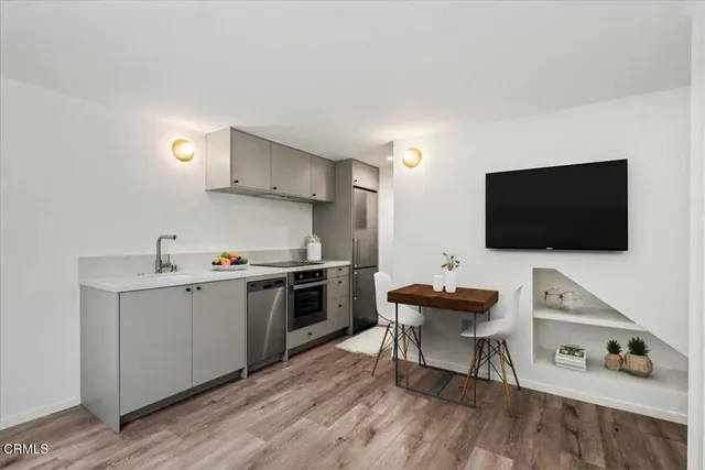 a kitchen with a sink and a stove top oven
