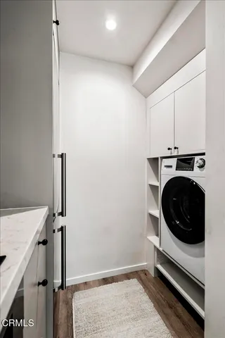 a utility room with sink dryer and washer